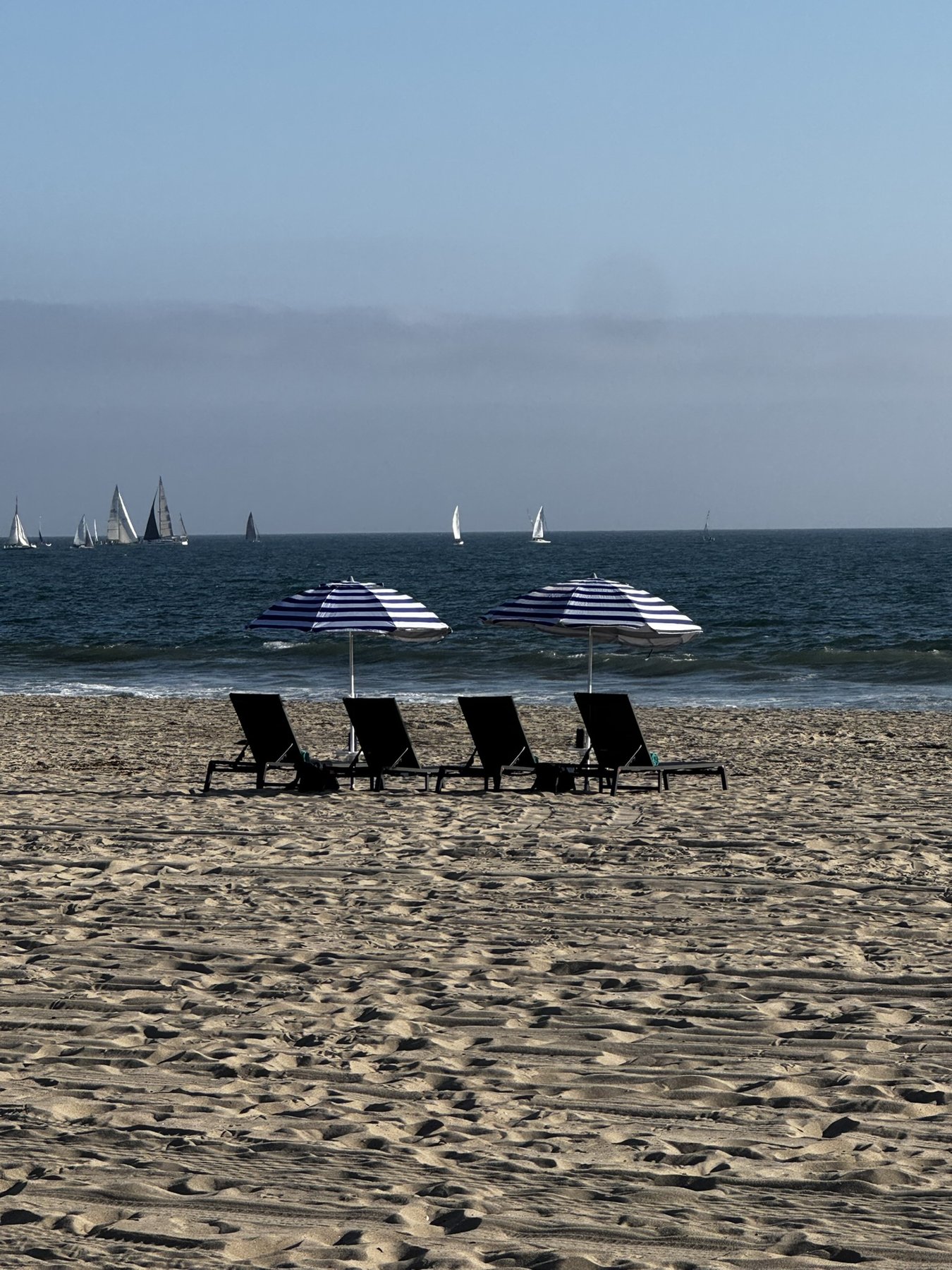 Chairs and shade waiting by the water